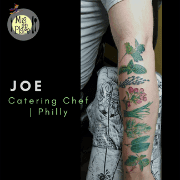 Colourful botanical sleeve tattoo running down an arm