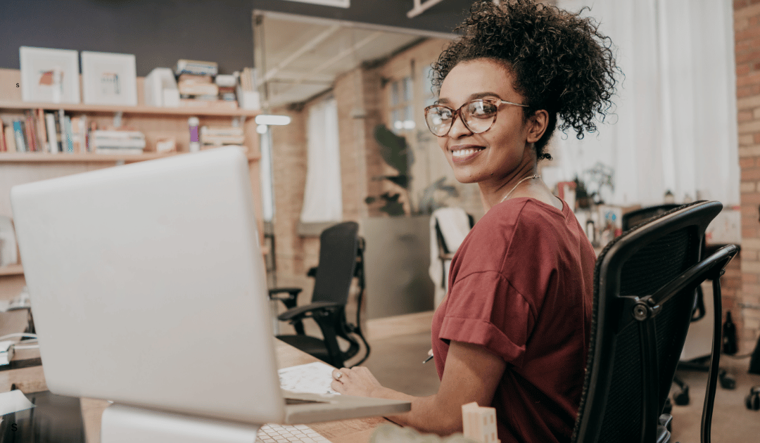 Restaurant worker sitting in a dining room looking back toward the camera, representing modern hiring trends in hospitality